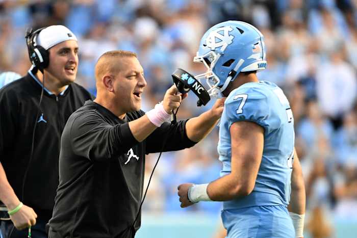 Oct 16, 2021; Chapel Hill, North Carolina, USA; North Carolina Tar Heels quarterback Sam Howell (7) with offensive coordinator Phil Longo after running for a touchdown in the third quarter at Kenan Memorial Stadium. Mandatory Credit: Bob Donnan-USA TODAY Sports